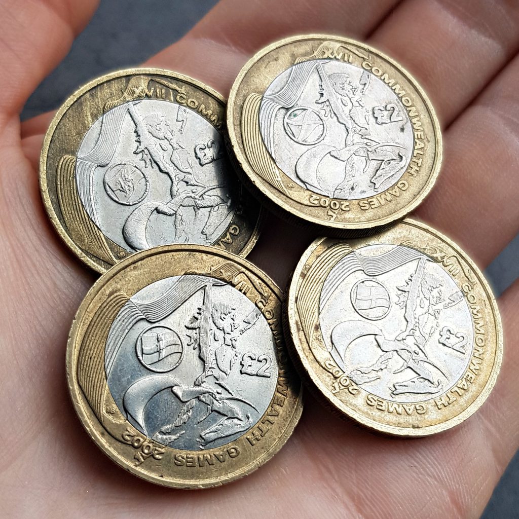 2002 Commonwealth Games £2 coins:
England, Scotland, Northern Ireland, and Wales. 
Photo of four coins in palm of the hand.