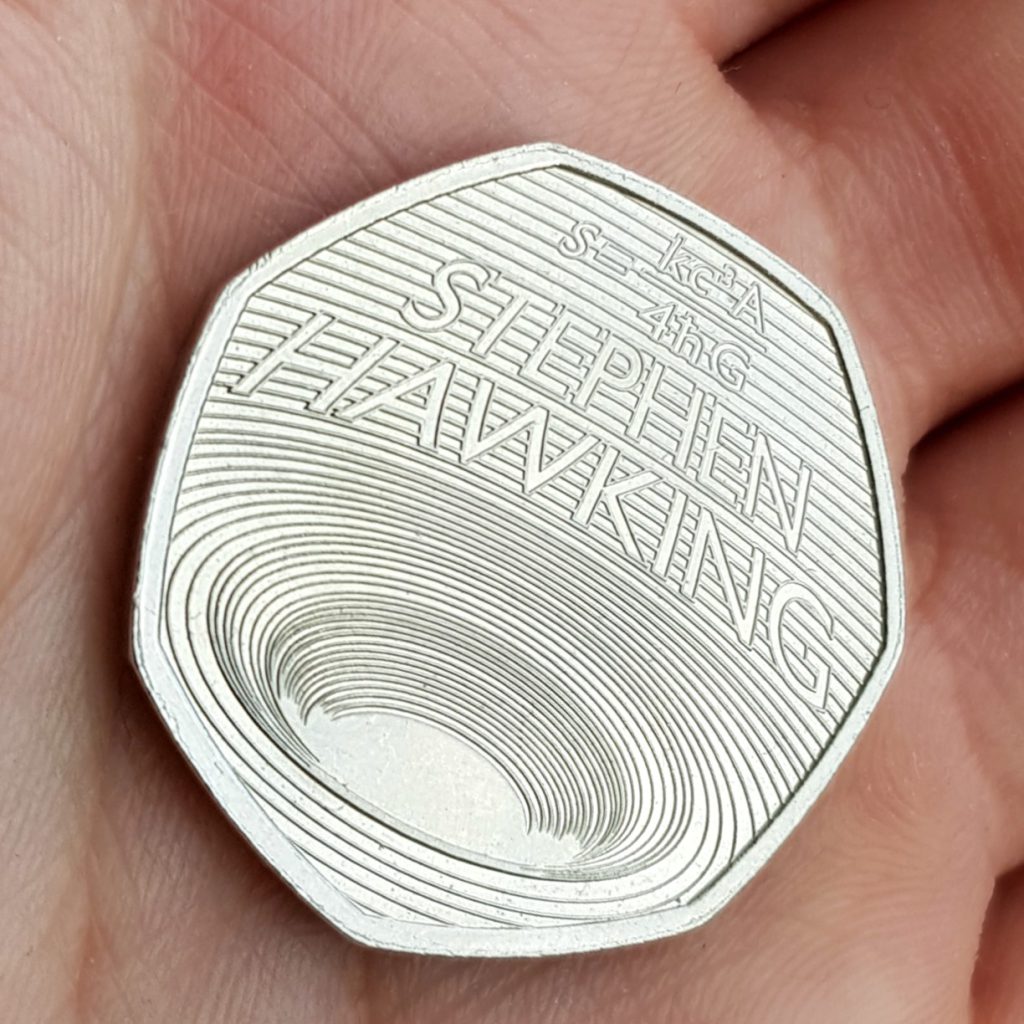 The 2019 UK Stephen Hawking 50p coin reverse design.
Concentric circles to represent a black hole, as theorised by Hawking. Featuring as inscriptions:
The Bekenstein-Hawking formula and 'STEPHEN HAWKING'