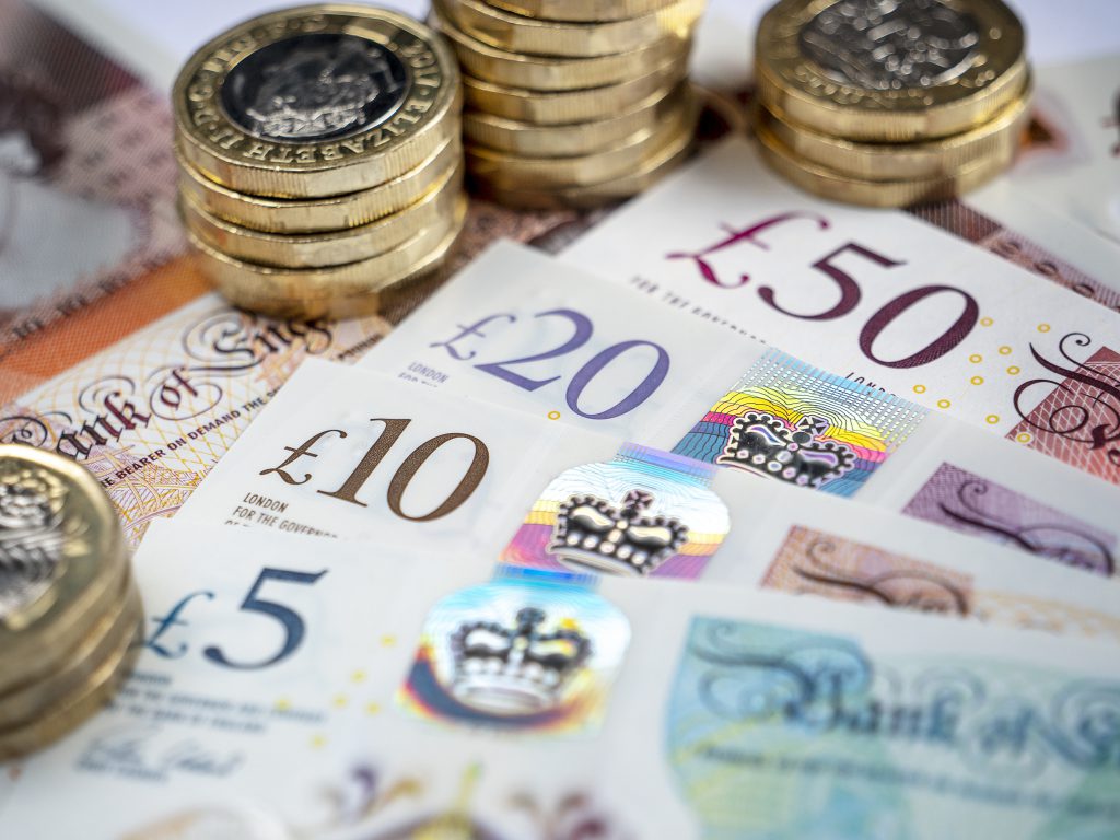 Close up image of British banknotes and coins.
